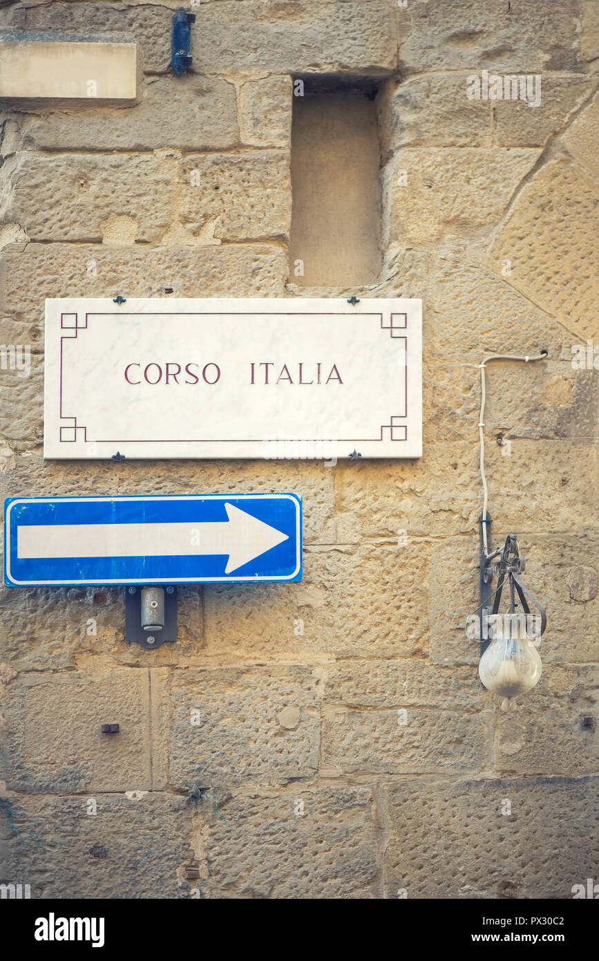 Street plate with the text Corso Italia on a wall Stock Photo