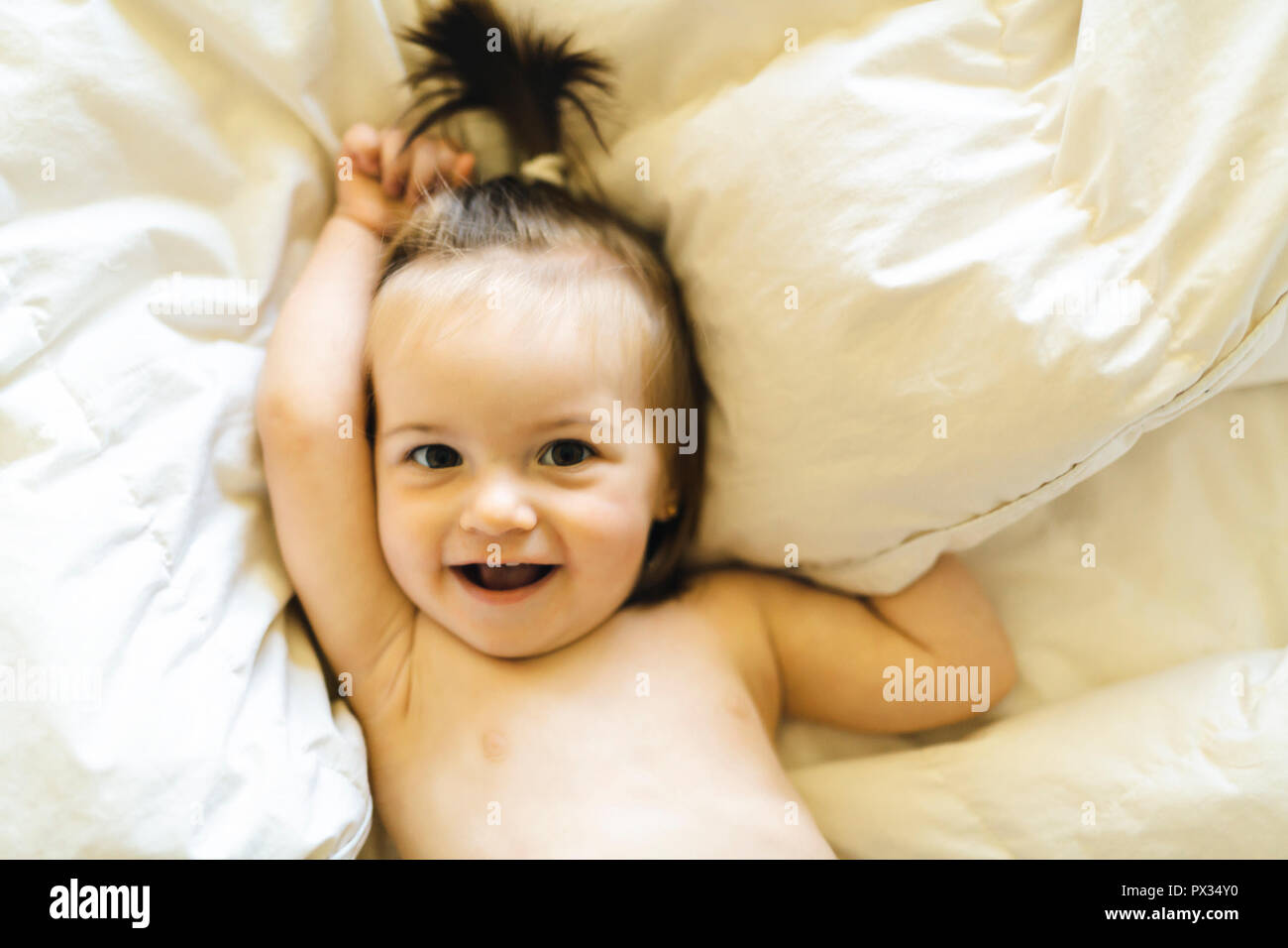 Cute little baby lying on bed at home Stock Photo - Alamy