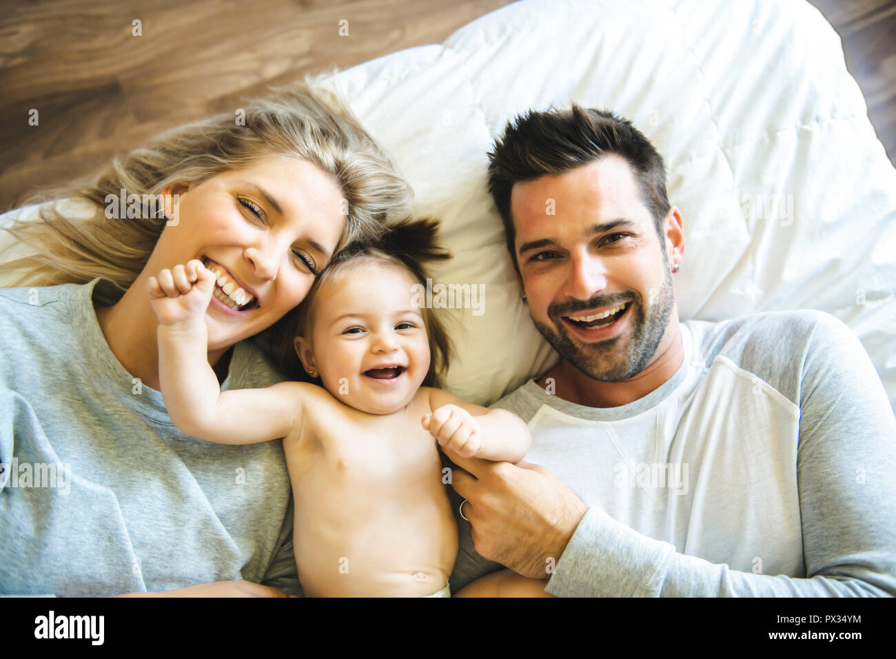 Family on bed with his baby on the morning Stock Photo