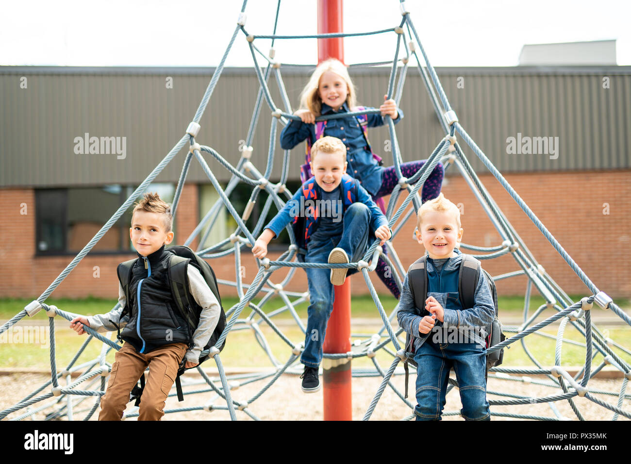 A happy excited kids having fun together on playground Stock Photo