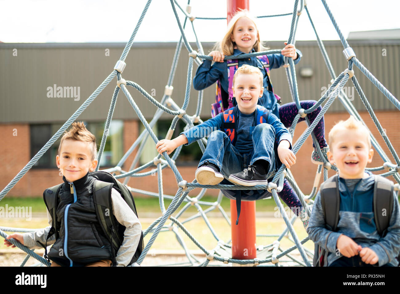 A happy excited kids having fun together on playground Stock Photo