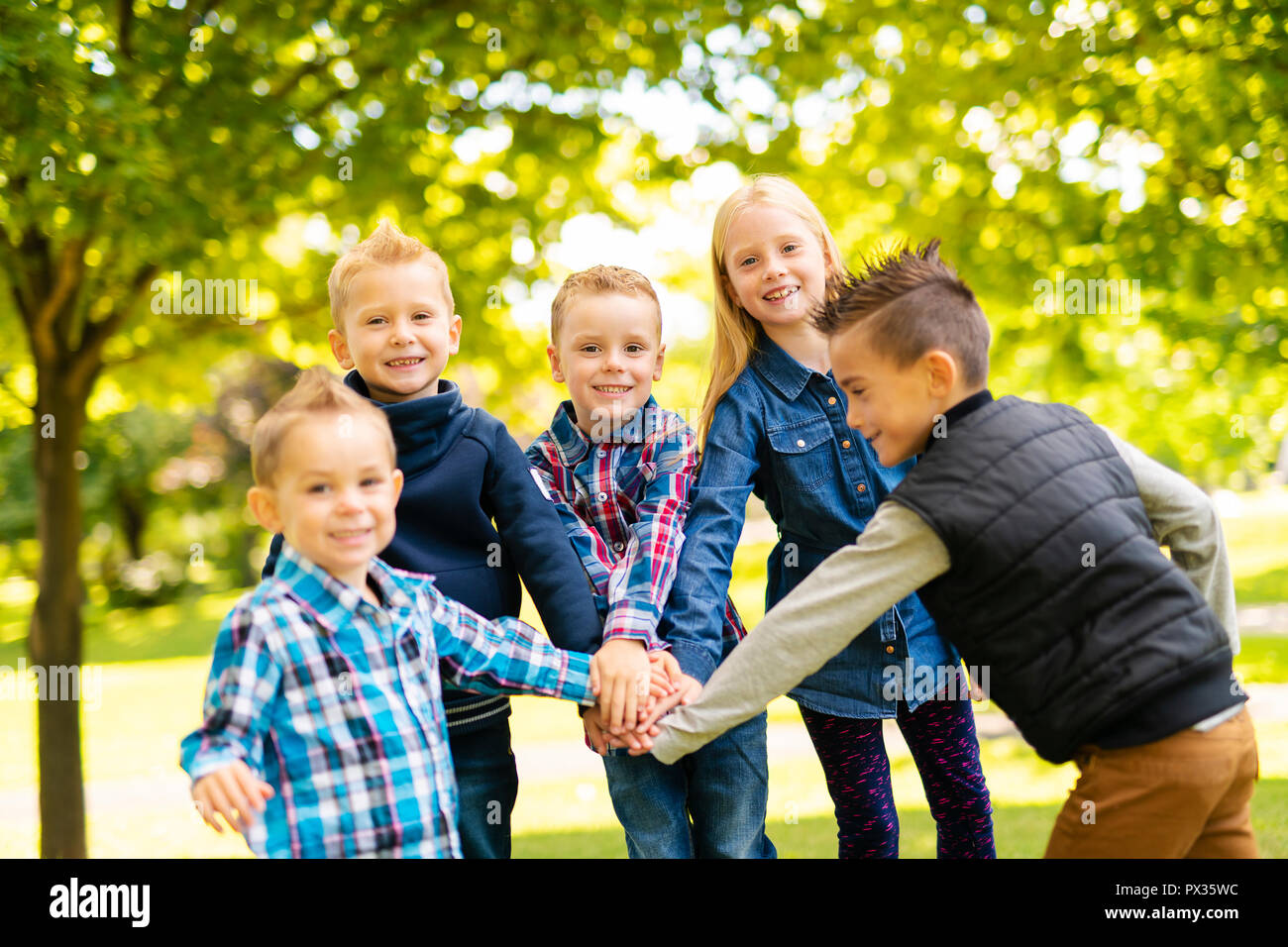 A group of children in spring field having fun Stock Photo
