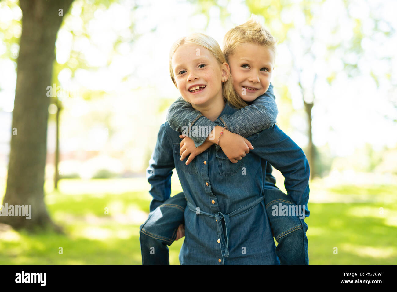 A Picture of brother and sister having fun in the park Stock Photo