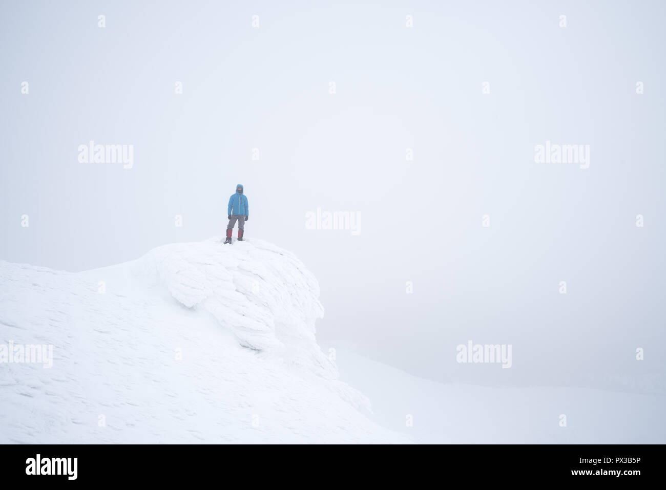 Snowy mountains in winter. Tourist photographer takes pictures with snow. Landscape in foggy weather Stock Photo