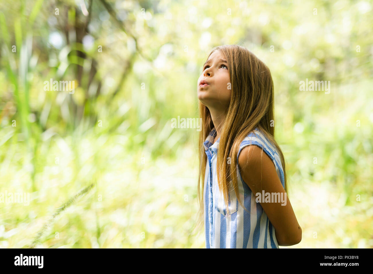 Portrait of a happy young girl outdoors forest Stock Photo - Alamy