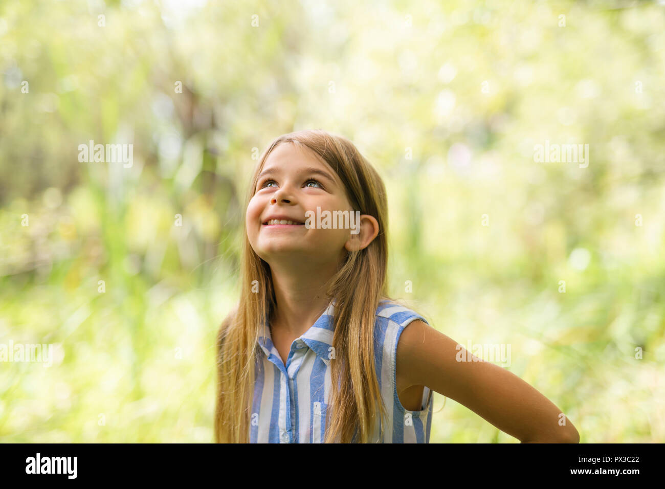 Portrait of a happy young girl outdoors forest Stock Photo - Alamy