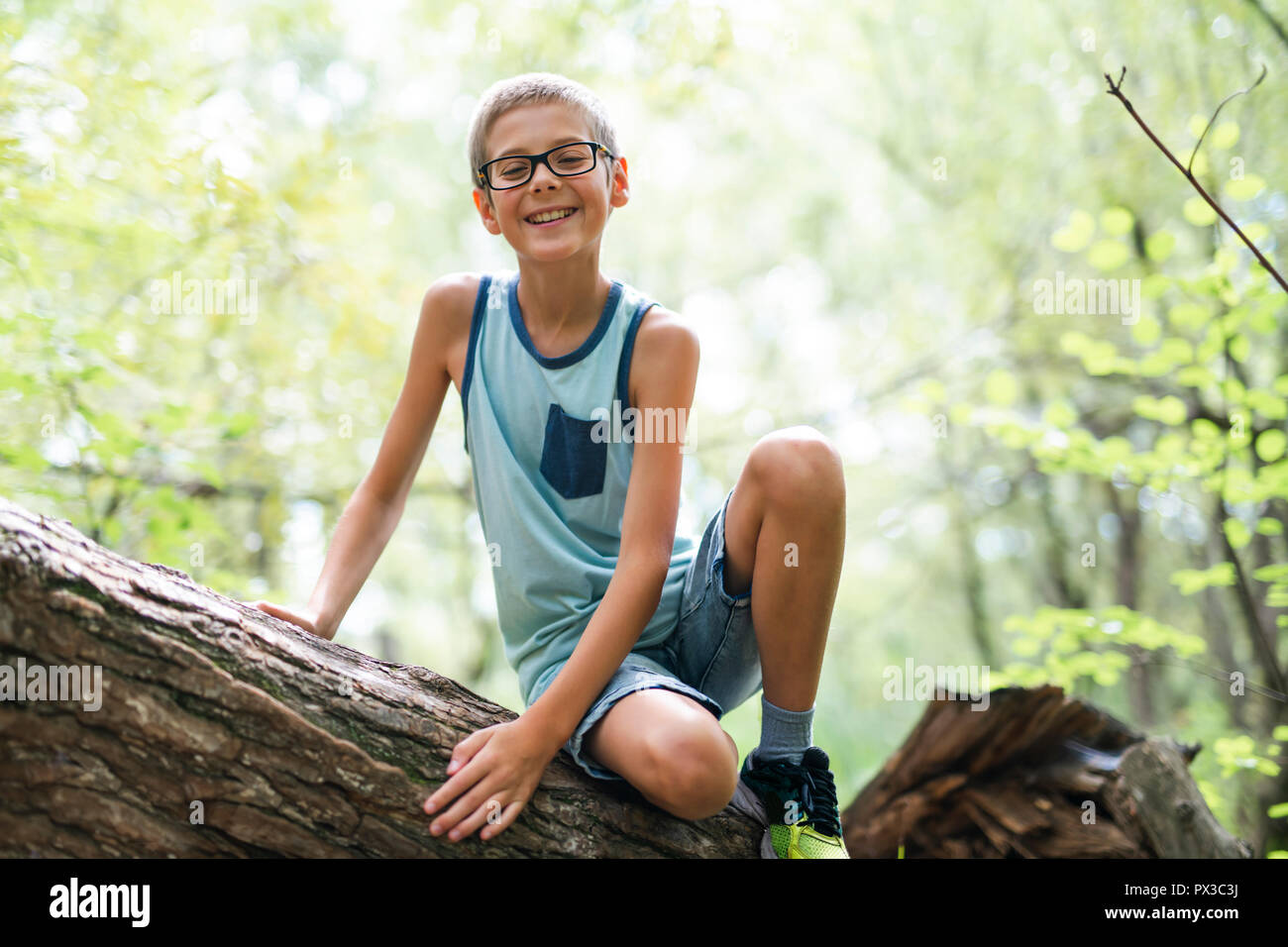Portrait of a happy young boy outdoors forest Stock Photo - Alamy
