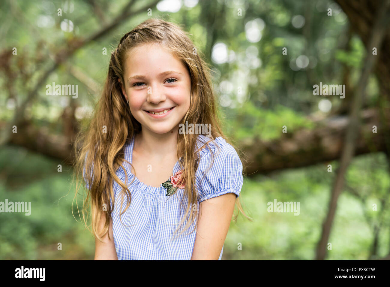 Portrait of a happy young girl outdoors forest Stock Photo - Alamy