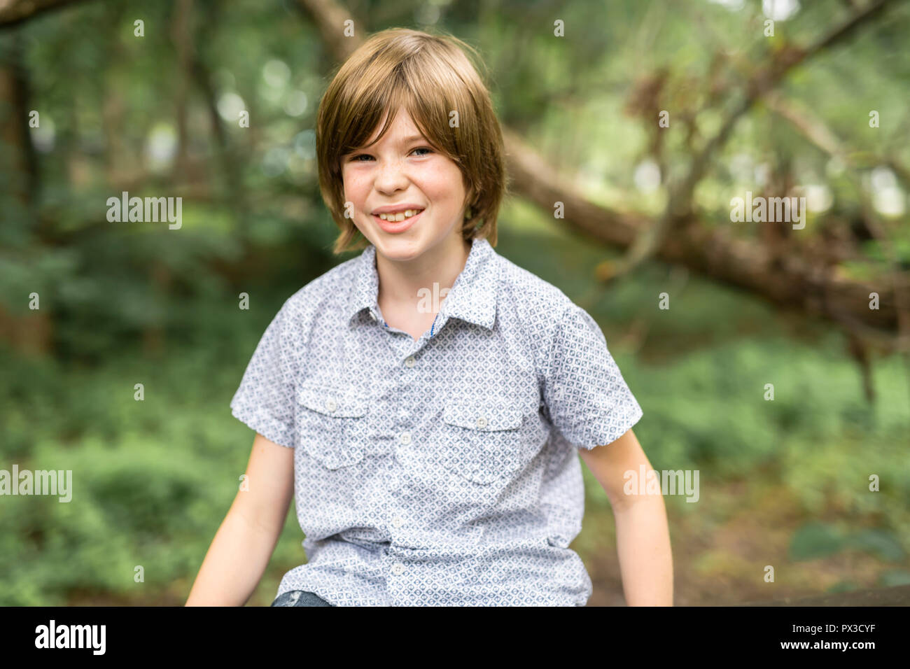 Portrait of a happy young boy outdoors forest Stock Photo - Alamy