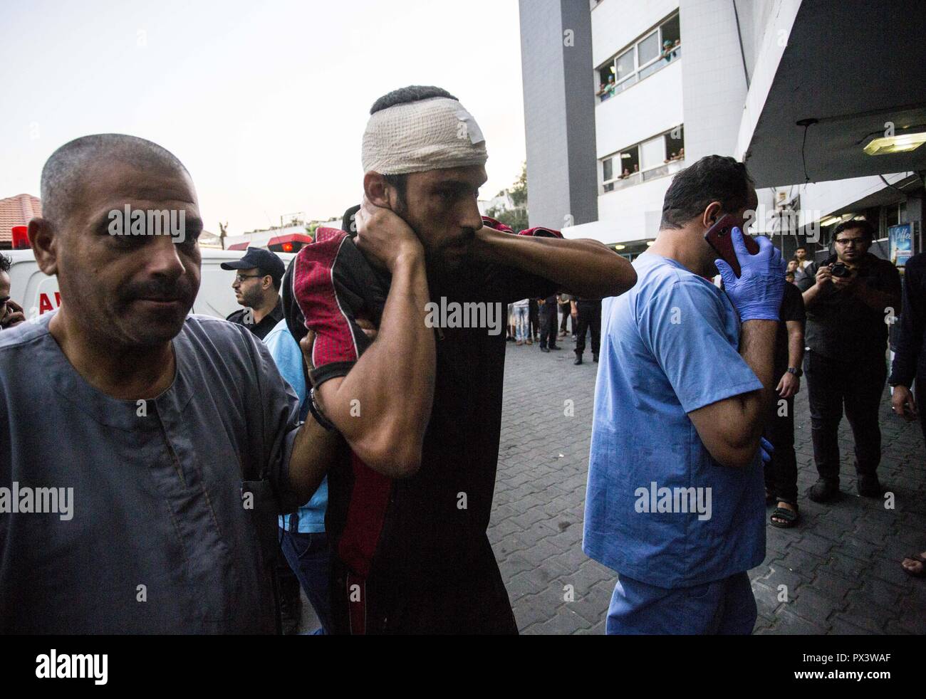 Gaza City, The Gaza Strip, Israel. 19th Oct, 2018. An injured demonstrator seen being brought to Shifa hospital to receive treatment during clashes.Clashes at the Israel border in an anti-occupation march near the eastern border in Gaza Strip. Credit: Mahmoud Issa/SOPA Images/ZUMA Wire/Alamy Live News Stock Photo