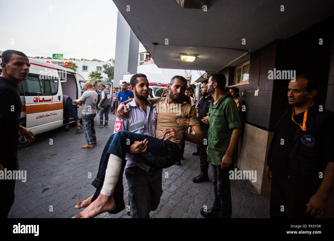 An injured demonstrator is seen being brought to Shifa hospital to receive treatment during the clashes. Clashes at the Israel border in an anti-occupation march near the eastern border in Gaza Strip. Stock Photo