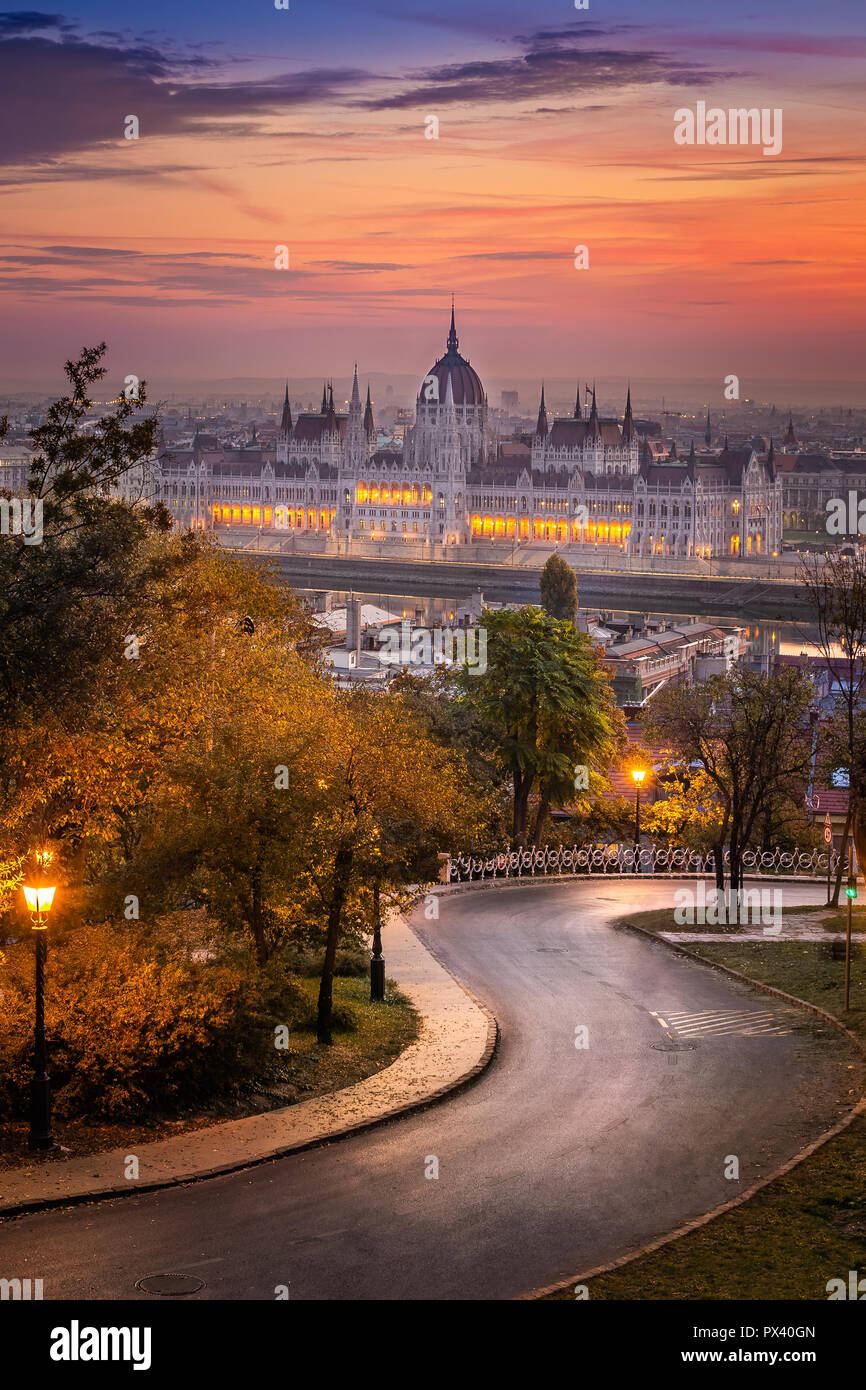 Budapest, Hungary - Curved road at Buda district with Parliament and colurful sunset sky Stock Photo