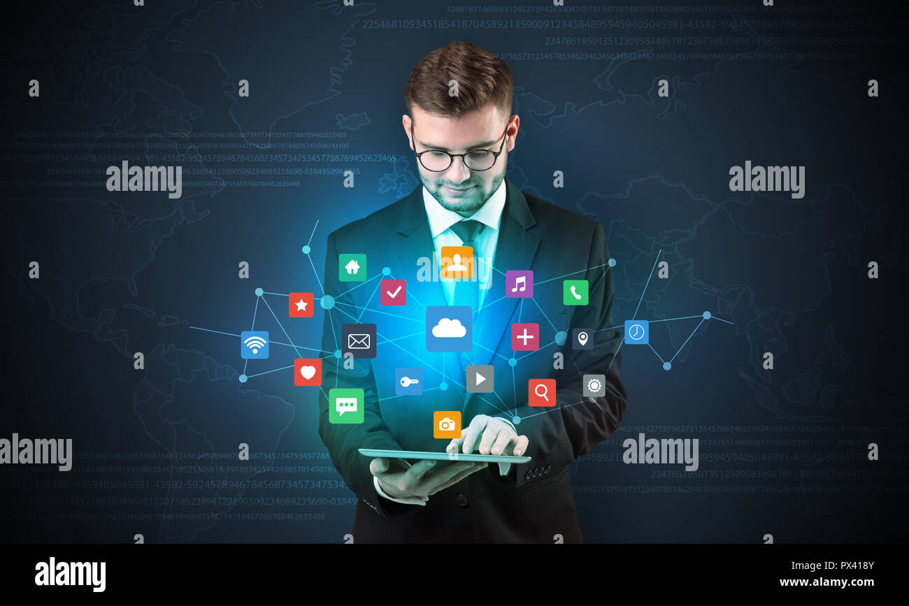 Handsome businessman in suit with tablet on his hand and application ...
