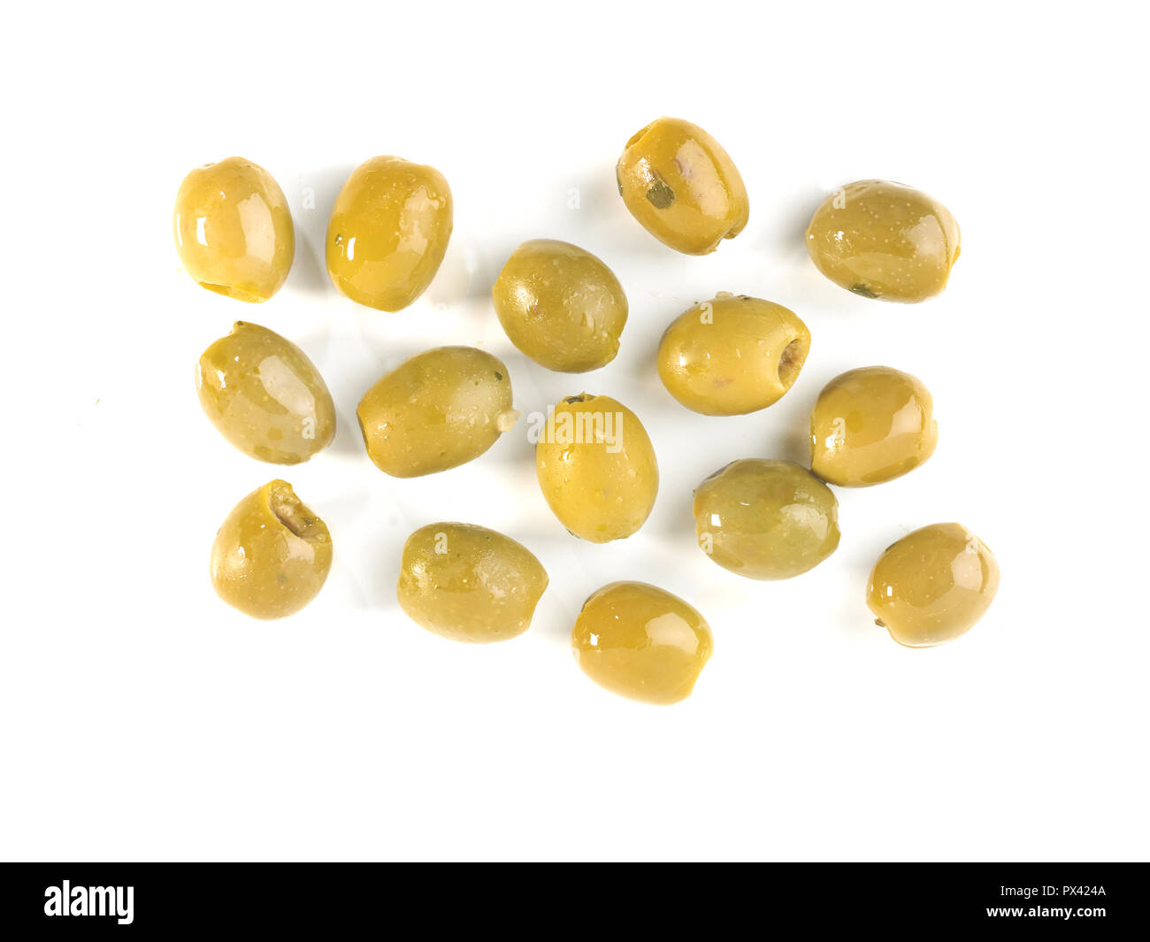 green olives with olive oil on a white background Stock Photo - Alamy