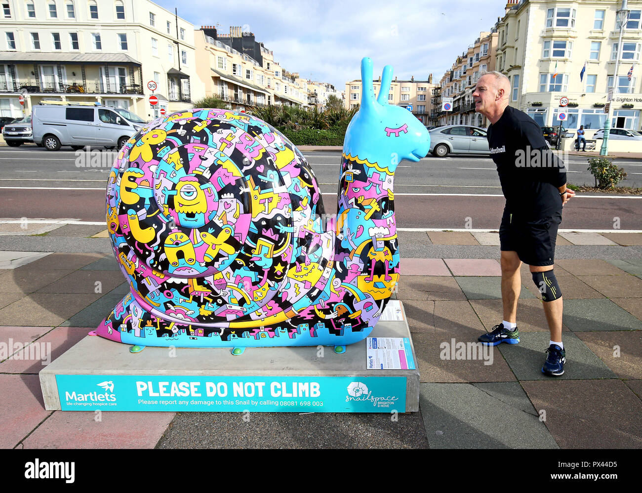DJ Norman Cook, also known as 'Fatboy Slim', as he becomes 'Fatboy Slow' for a day, hunts down 50 giant snail sculptures around Brighton and Hove to raise money for the Martlets hospice. Stock Photo