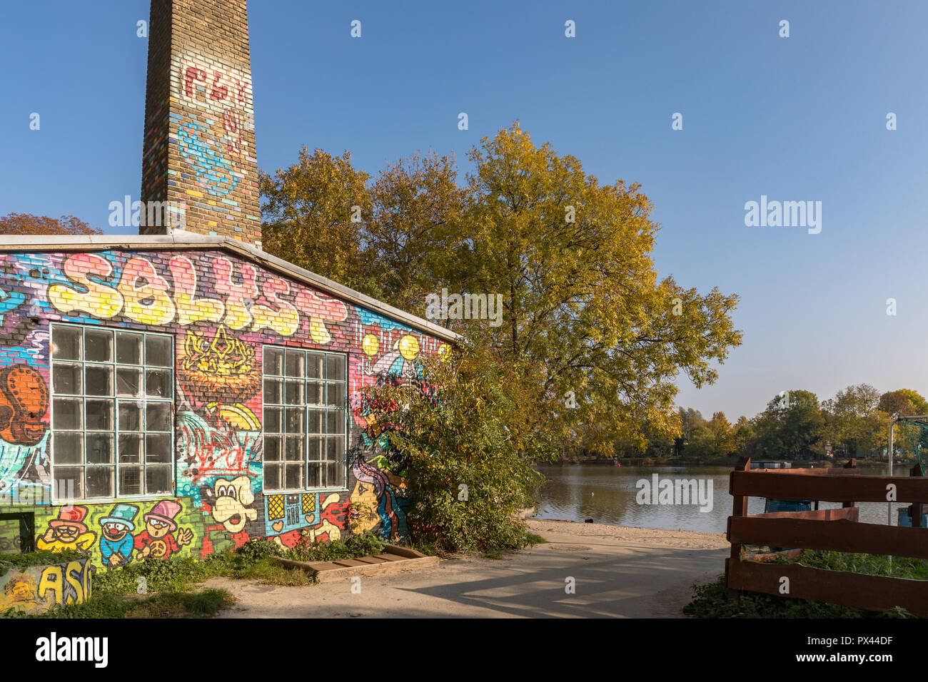 COPENHAGEN, DENMARK - October 2018: Building with grafitti by the canal in Freetown Christiania, a self-proclaimed autonomous neighbourhood in Copenhagen. Stock Photo