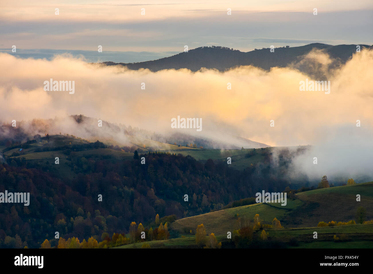cloud inversion at dawn. lovely autumn scenery of mountainous rural area Stock Photo