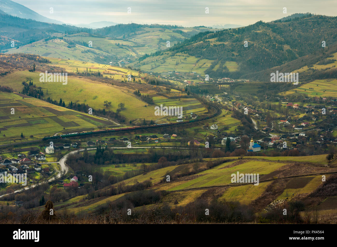 village in the valley. bird eye view. rail road and viaduct in the distance. mysterious autumn weather Stock Photo