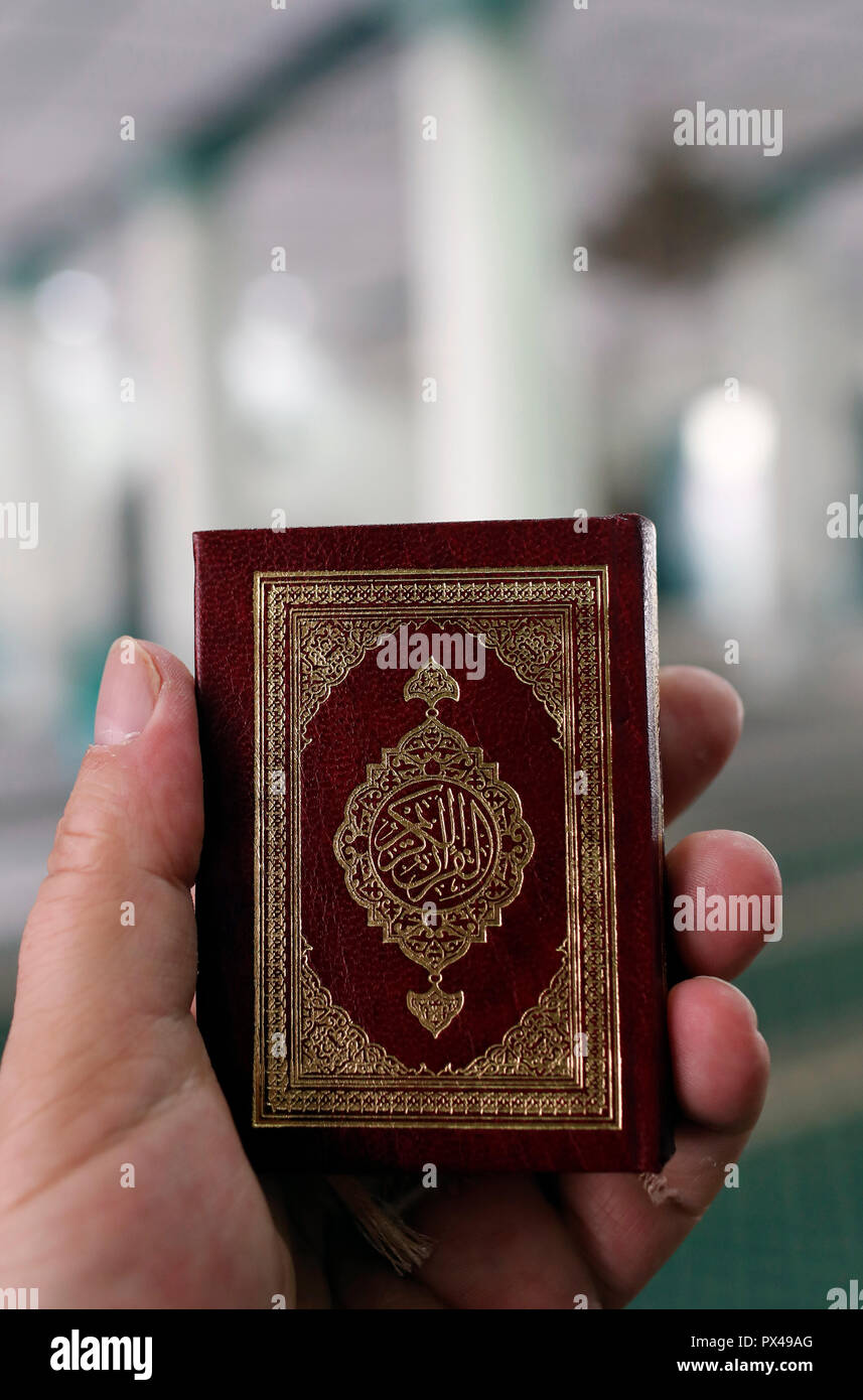 The Green Mosque. Muslim man reading an Arabic Holy Quran (Koran