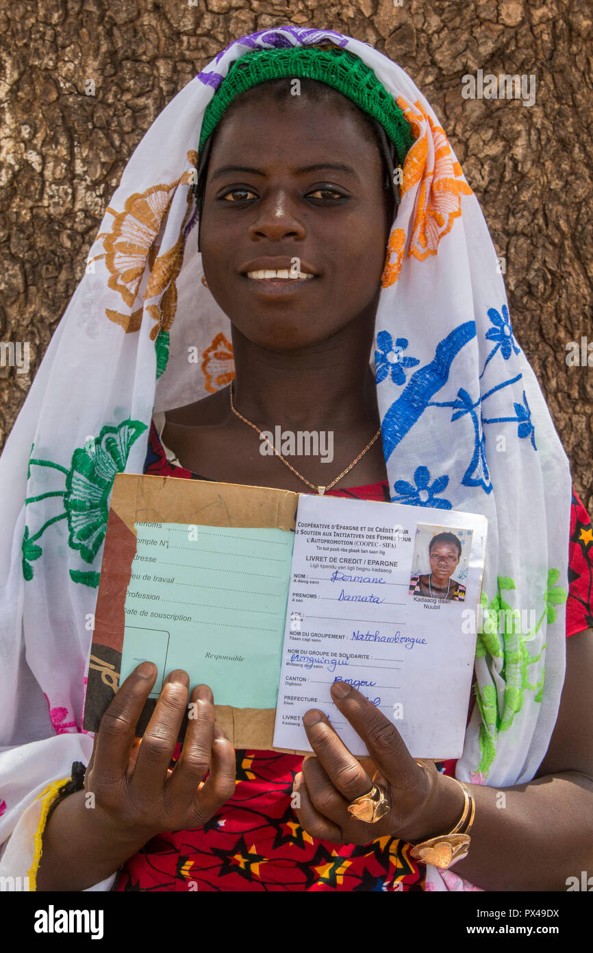 Member of a women's microfinance cooperative showing her savings book in Northern Togo. Stock Photo