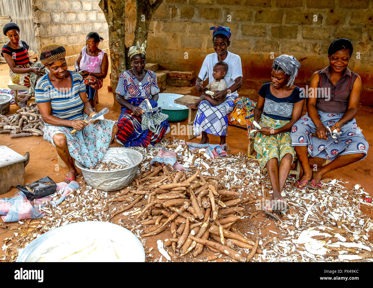 Group Of Women Peeling Cassava On The Outskirts Of Loma C Togo Stock Photo Alamy