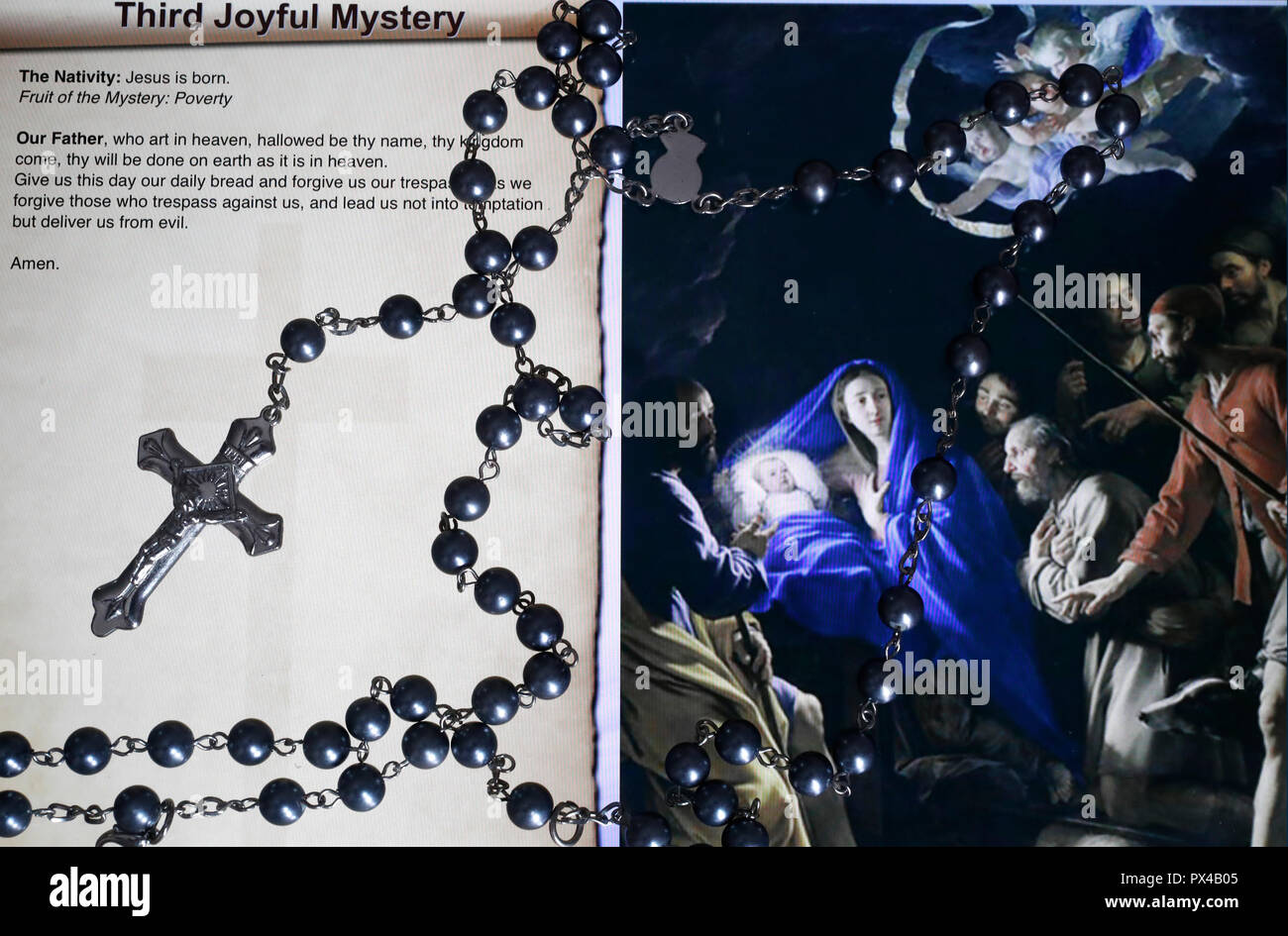 Christian Rosary on a digital tablet.  Catholic prayer. The Third Joyful Mystery : the Nativity. Stock Photo