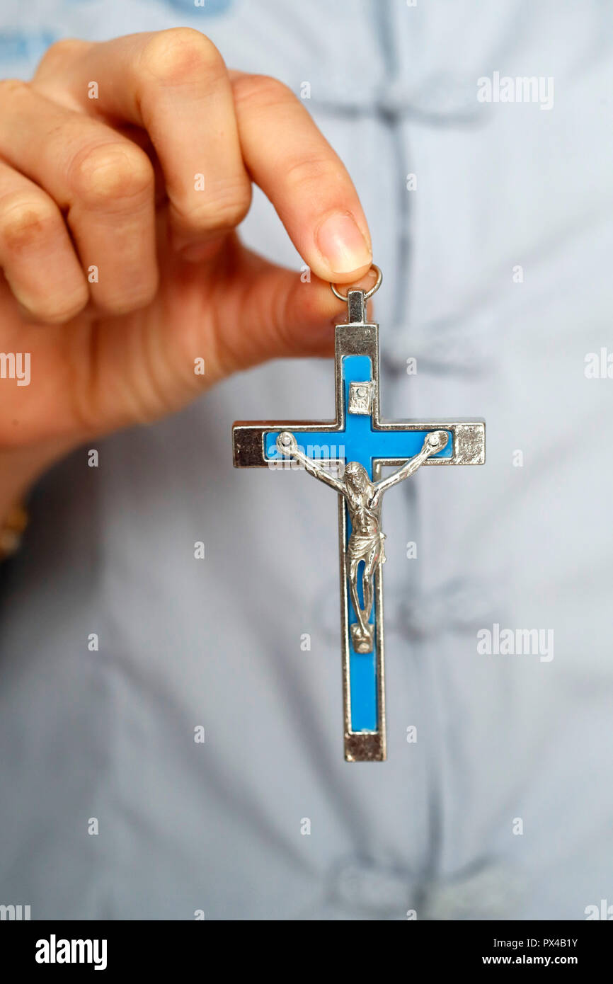 Woman with a crucifix in hand. Close-up. Stock Photo