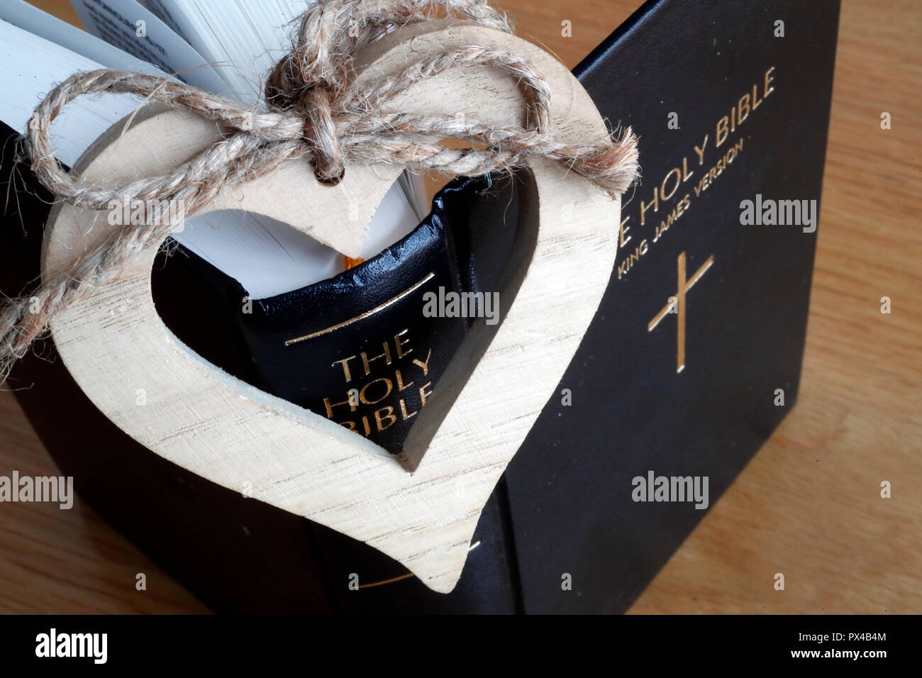 A wooden heart and  the Holy Bible. Stock Photo
