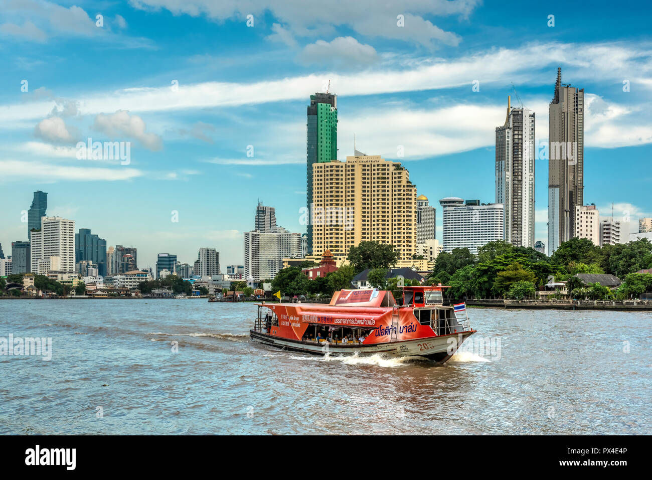 Chao Phraya express boat and city skyline, Bangkok, Thailand Stock Photo