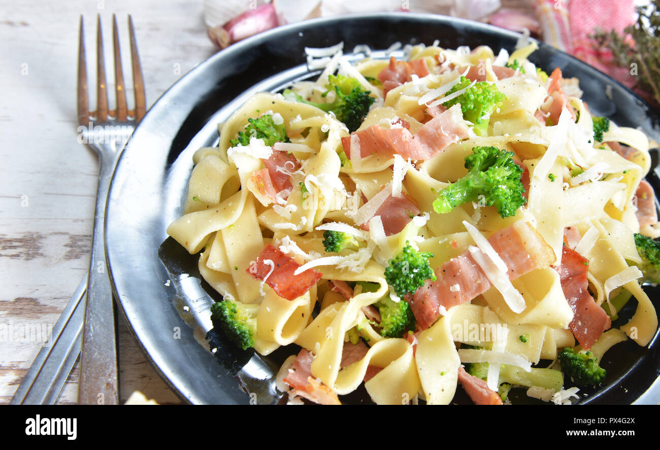 Tagliatelle pasta with broccoli and prosciutto Stock Photo Alamy