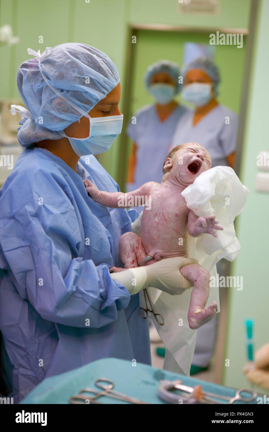 Nurse with newborn baby after Caesarean section, birth in hospital, Czech Republic Stock Photo