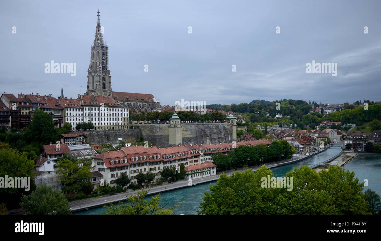 Bern Cathedral viewed from the riverside with the waterfront in the foreground Stock Photo