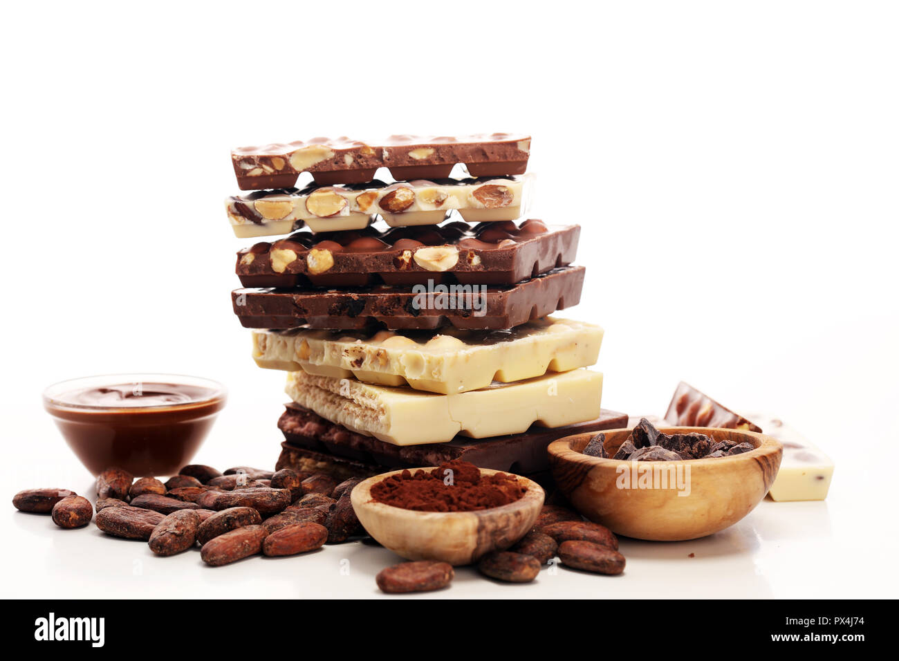 Chocolate bars on table with chocolate tower. Chocolate and nuts Stock Photo