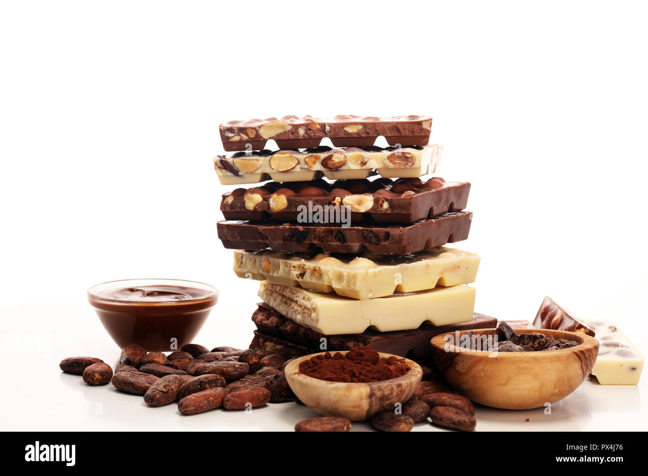 Chocolate bars on table with chocolate tower. Chocolate and nuts Stock Photo