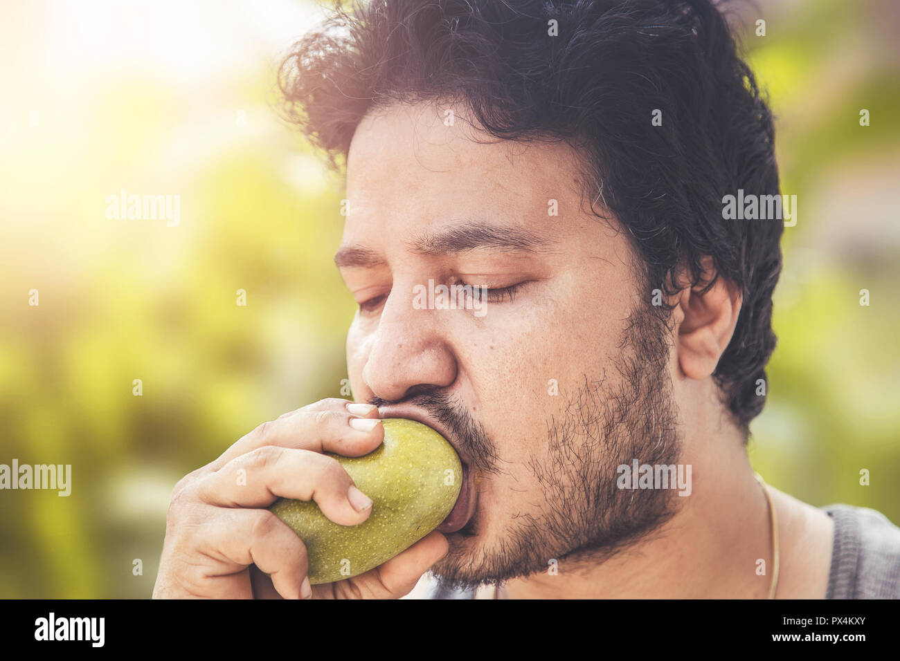 Indian man eating mango Stock Photo Alamy