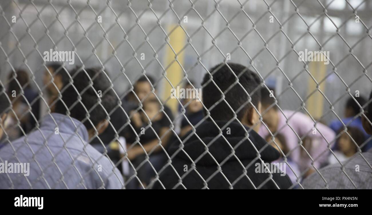Alleged illegal border crossers behind the fence at the Central Processing Center in McAllen, Texas, June 17, 2018. Image courtesy United States Department of Defense. () Stock Photo