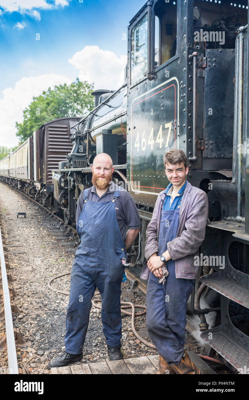 The driver and fireman of ex-LMS Ivatt steam loco 46447 at the East Somerset Railway in Cranmore, Somerset, England, UK Stock Photo