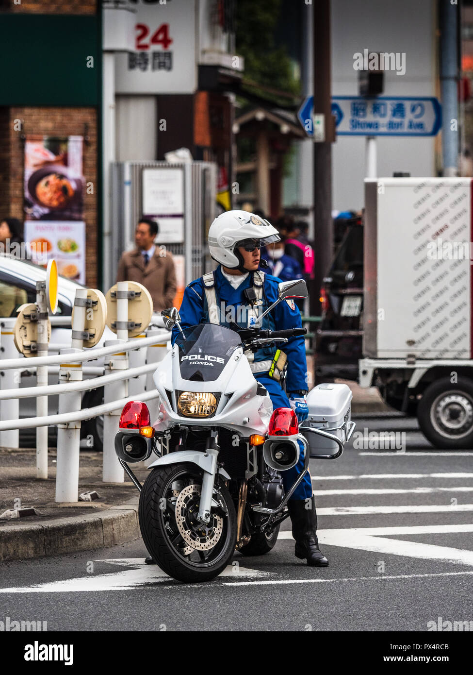 Tokyo Japan Police Motorcyclist waits at a junction in Tokyo Stock Photo