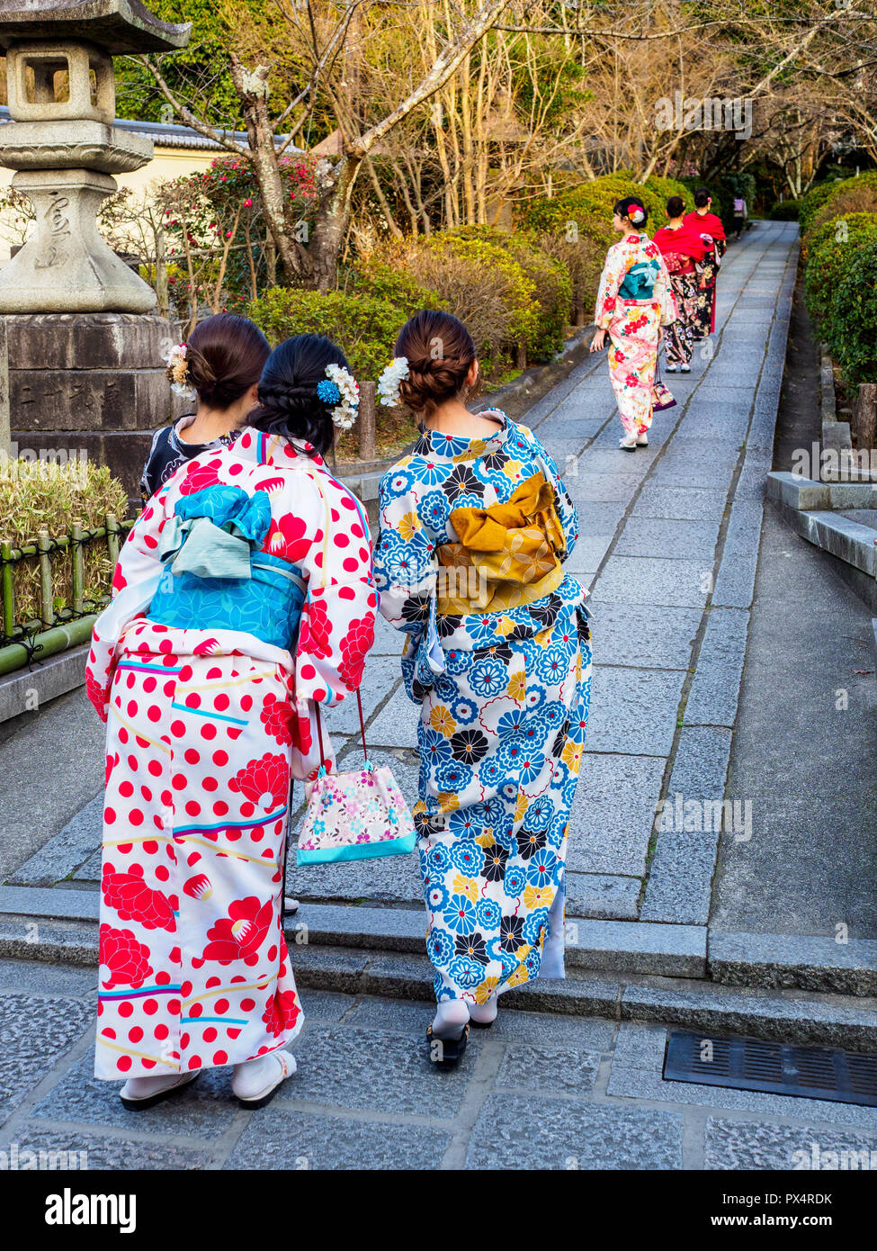 Kyoto Japan Kimono Traditional Japanese Dress - women walk to the temple dressed in traditional kimono robes in the Japanese city of Kyoto Stock Photo