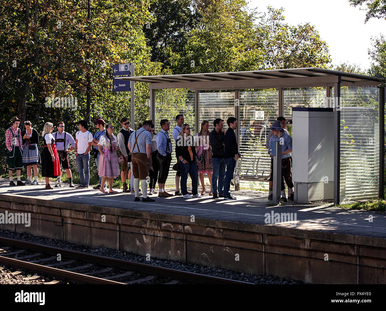 Oktoberfest party goers obtaining tickets at Riem Station on the U-Bahn on a glorious sunny day in late September. Stock Photo
