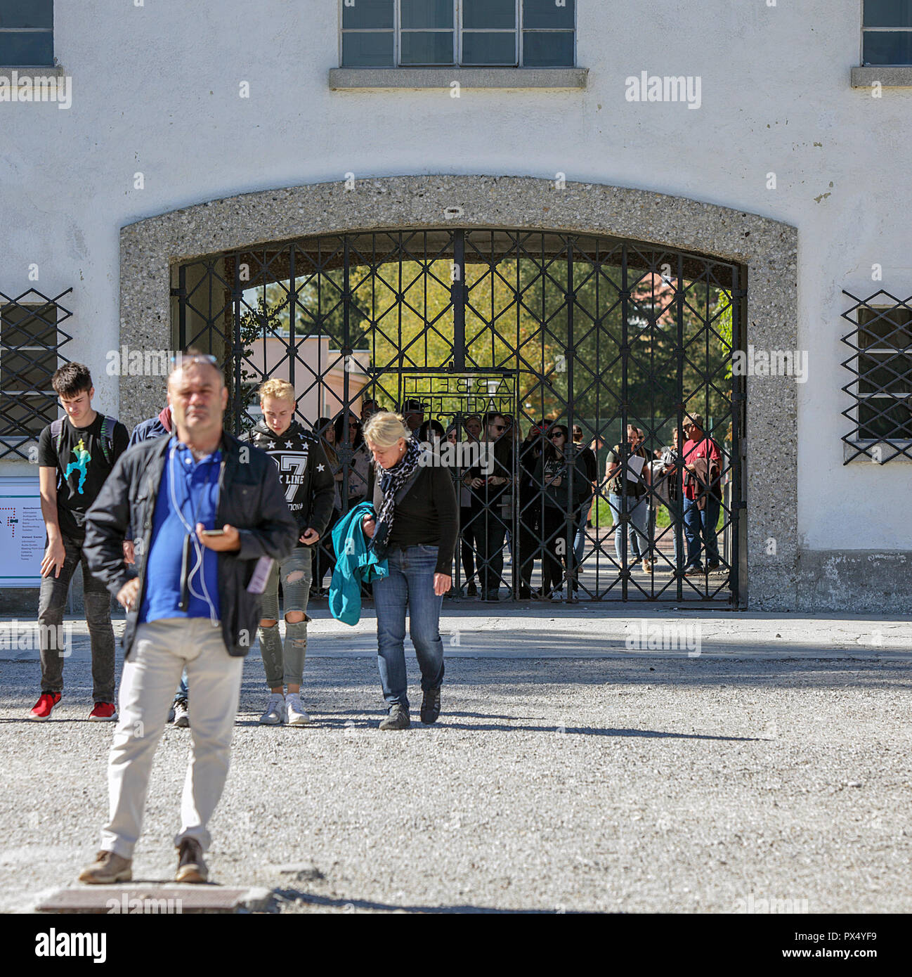 The entrance/exit to Dachau Concentration Camp in Germany with accompanying tourists/visitors. Stock Photo