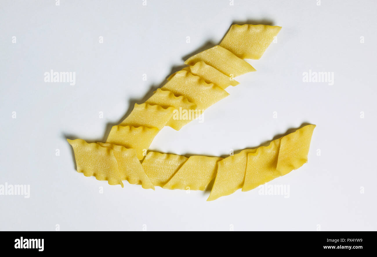 Dry Italian pasta called pantacce on a white background ,rhombus
