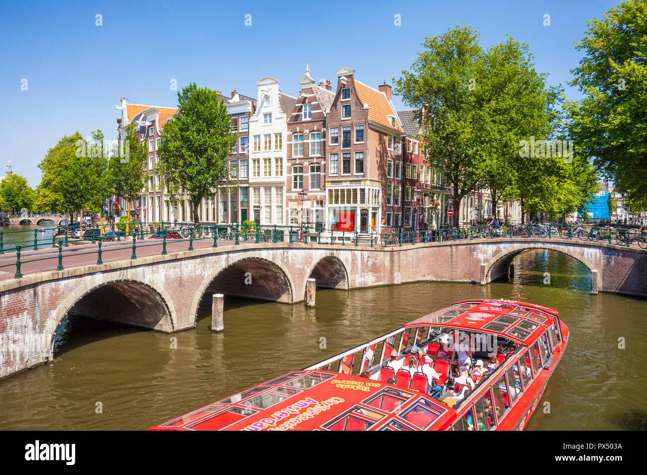 Amsterdam canal boat going under the bridges of Leidsegracht canal at the junction with Keizergracht canal Amsterdam Netherlands Holland EU Europe Stock Photo