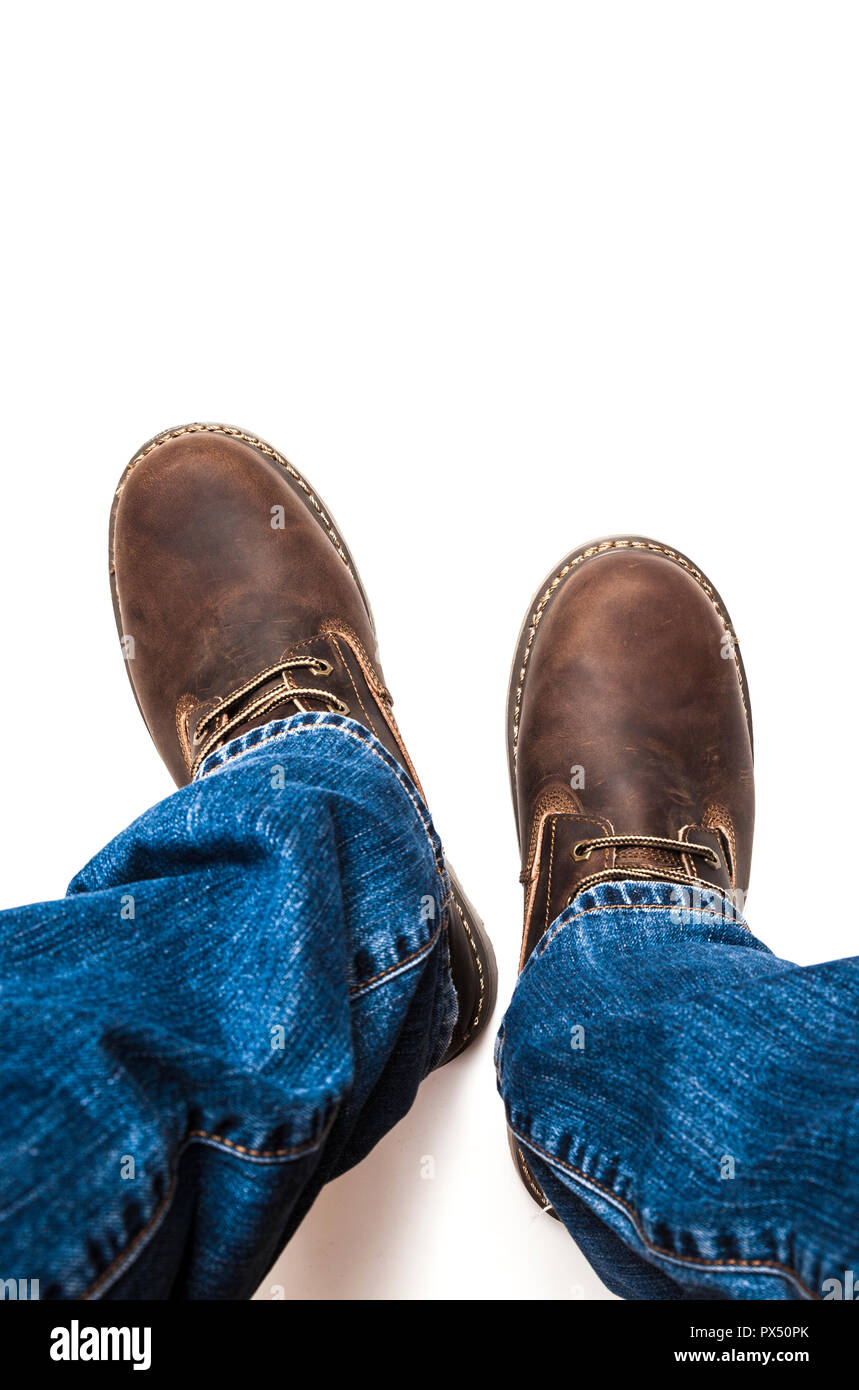 Men's brown boots and blue jeans isolated Stock Photo Alamy