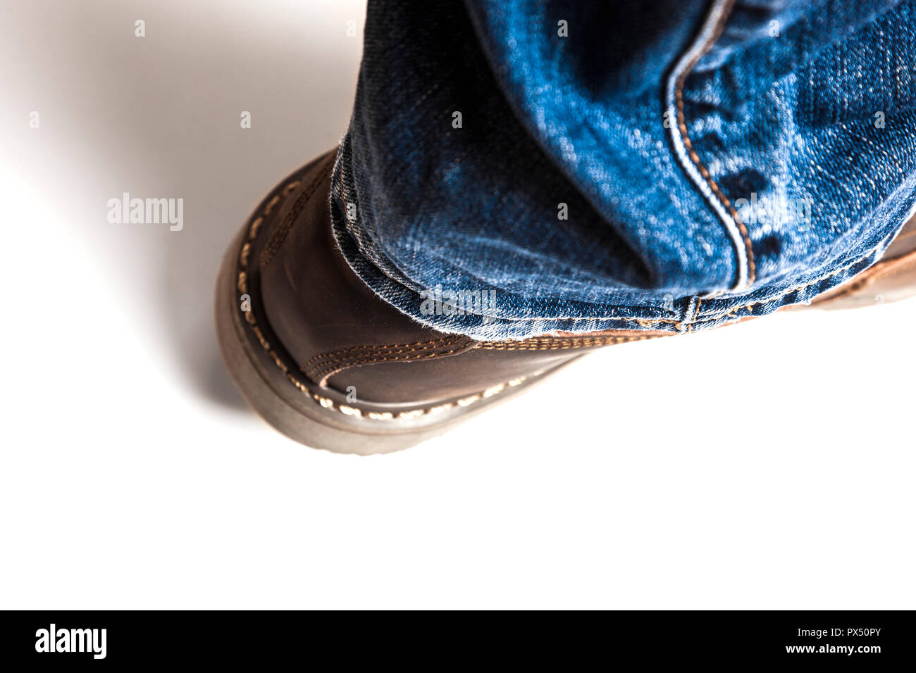 Men's brown boots and blue jeans isolated Stock Photo Alamy
