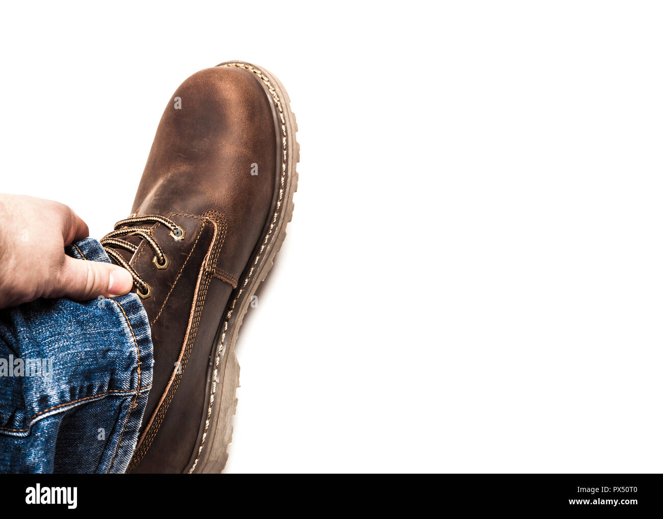 Men's brown boots and blue jeans isolated Stock Photo