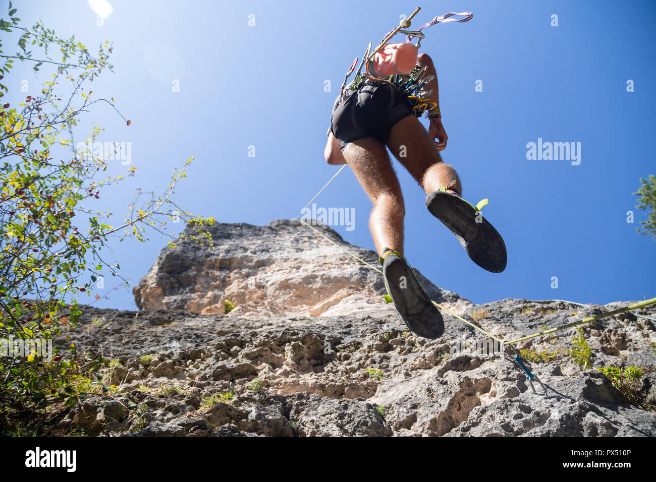 Young man rope climbing rocky hi-res stock photography and images - Alamy