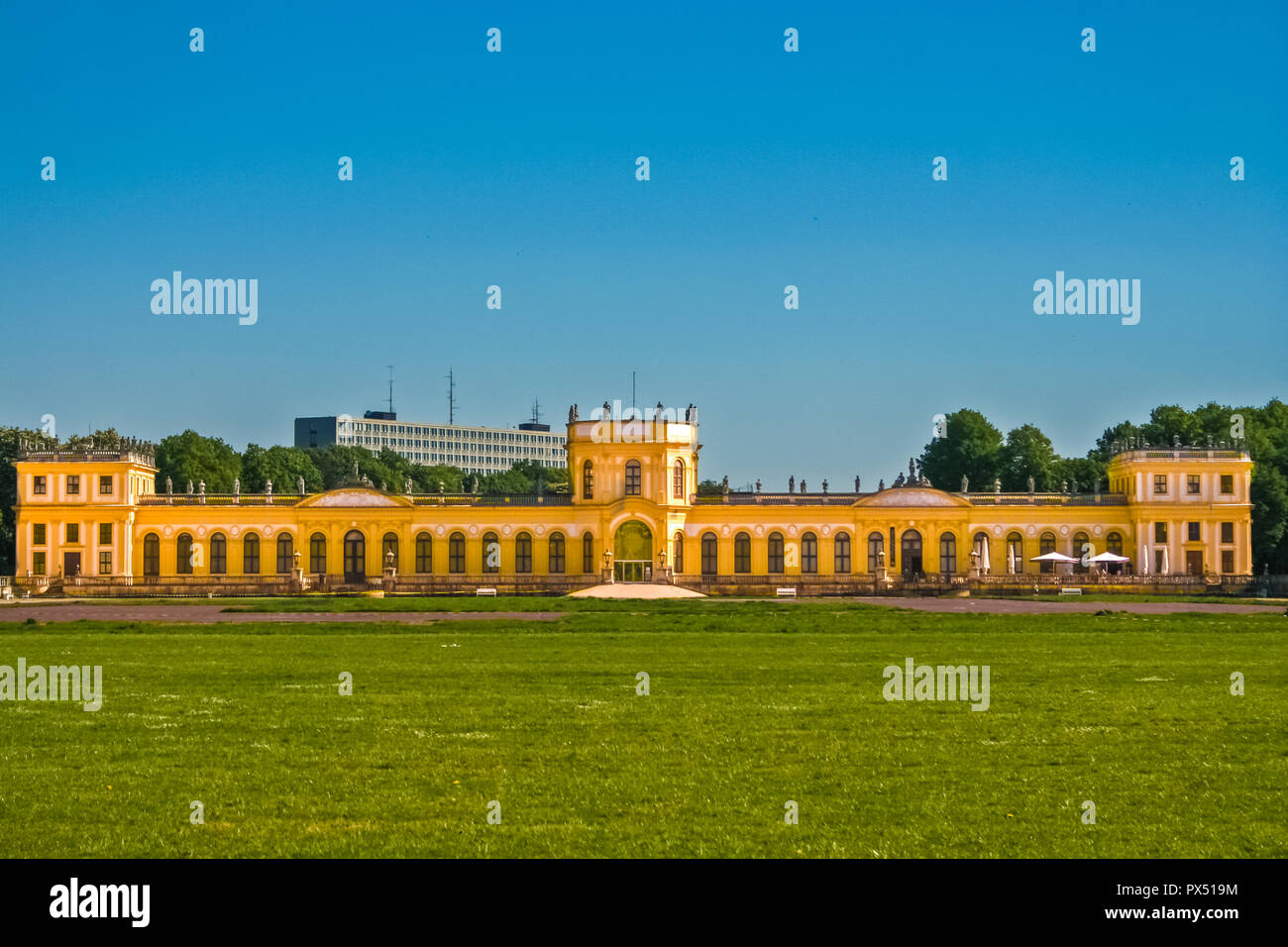 Beautiful front view of the Orangerie, a baroque castle at the northern corner of the Karlsaue park in Kassel, Germany. The bright yellow walls of the... Stock Photo