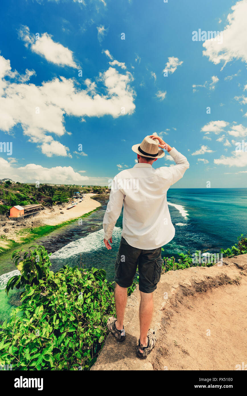 Enjoying life. Back side of young man looking at the sea, vacations  lifestyle concept Stock Photo - Alamy