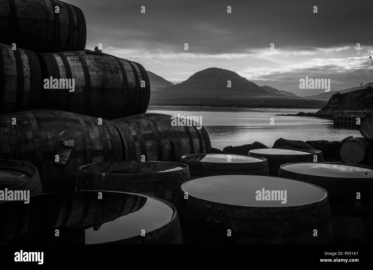 Bunnahabhain whisky distillery, looking towards the Paps of Jura, in Bunnahabhain, Scotland. Stock Photo